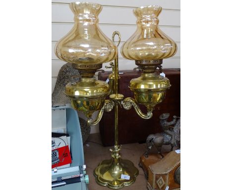 A twin-branch brass oil lamp with lustre shades, height 70cm overall 