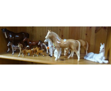 A shelf of horse ornaments 