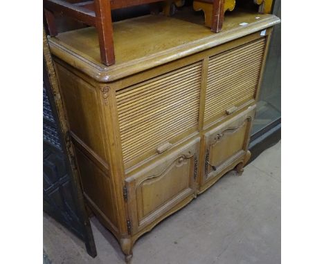 A French light oak cabinet, with 2 tambour slides and cupboards under, on cabriole legs, W102cm, H103cm 