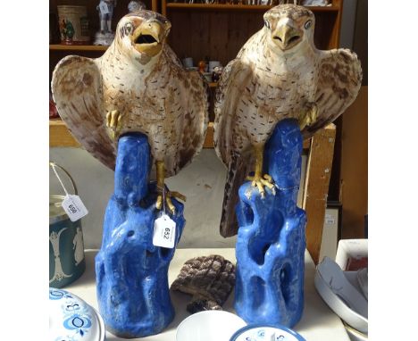 A pair of Continental glazed pottery ceramic eagles, height 48cm, both A/F 