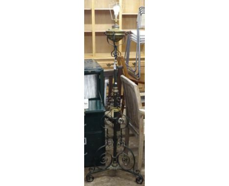 A Victorian scrolled and painted wrought-iron telescopic oil lamp, converted to electric 