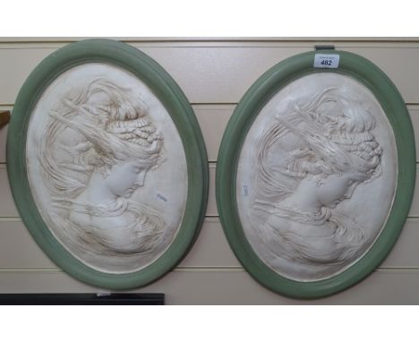 2 wall plaques with portrait decoration, height 42cm, and a porcelain framed wall mirror 