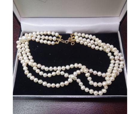 A triple-strand pearl choker necklace, with 9ct gold clasp 