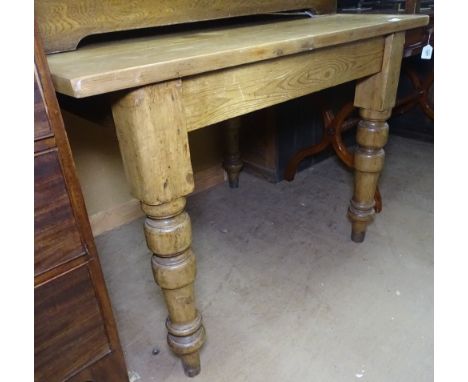 A Vintage pine plank-top kitchen table, with baluster legs 