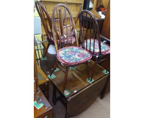 An oak oval drop leaf dining table, together with a set of 6 elm stick-back dining chairs 