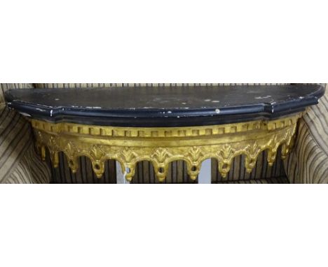 A small Victorian ebonised and gilded wall-mounted bow-front shelf, W60cm 