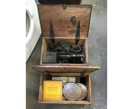 Cased Film Projector and Film Canisters with Films 