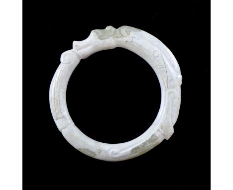 Chinese green and white carved hardstone ring in the form of a dragon, 5.5cm diameter, Wear.