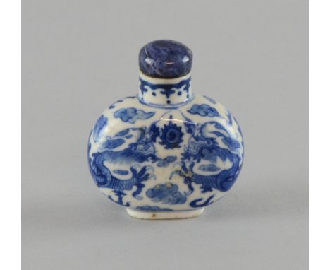 Chinese porcelain blue and white snuff bottle and stopper decorated with two dragons chasing the flaming pearl, on oval foot,