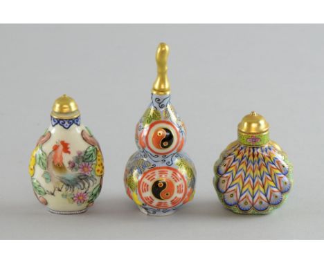 Three modern Chinese porcelain snuff bottles with moulded and painted decoration of a cockerel, feathers and symbols, tallest