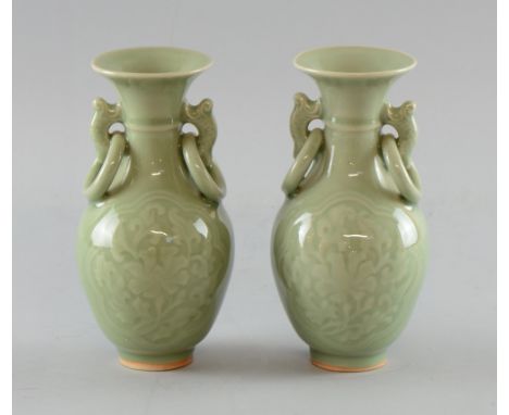 Pair of Chinese celadon vases of baluster form with moulded floral decoration and ring handles, 17.5cm high, Minor glaze faul