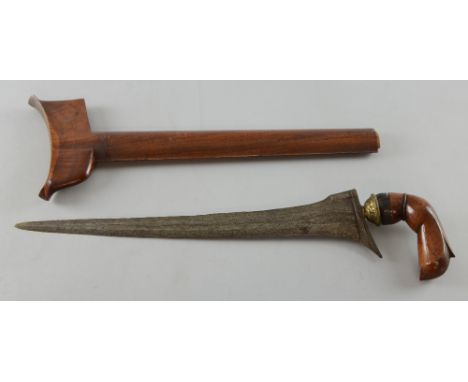 Malaysian 'Kris' dagger with layered blade, carved wooden handle and sheath, 46cm long, Blade very worn. Handle loose, chippe