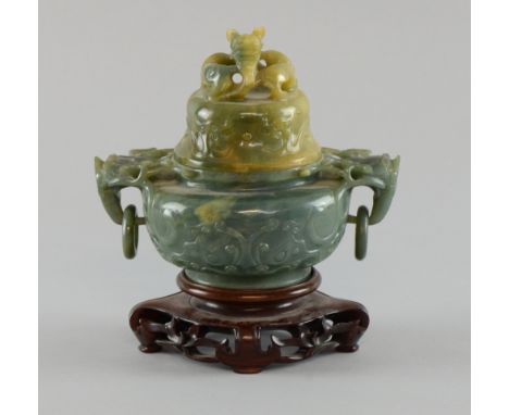 Chinese carved green hardstone censer and cover with lion mask and ring handles, the cover with dragon finial, on carved hard