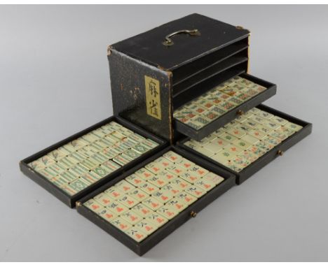 Chinese ceramic Mah-jong set in black painted five-drawer case, case 23cm wide, Each tile is 3cm x 2cm, some staining to the 