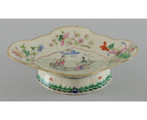 Chinese famille rose porcelain dish with shaped borders decorated with two figures on a tree trunk on a river with a cloud ab