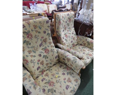 PAIR OF ERCOL LIGHT ELM FRAMED SWIVEL RECLINING ARMCHAIRS WITH BEIGE FLORAL CUSHIONS.