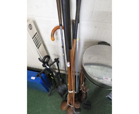 FIVE EARLY WOODEN GOLF CLUBS AND WALKING STICK WITH APPLIED BADGES.