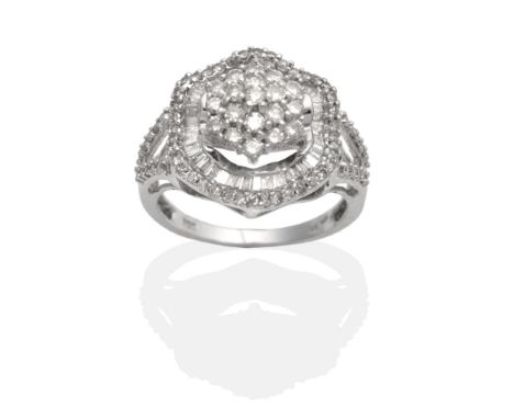 A Diamond Cluster Ring, a central cluster of round brilliant cut diamonds in claw settings within an undulating frame of bagu