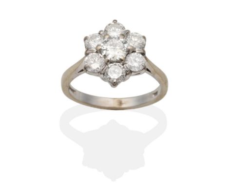 An 18 Carat White Gold Diamond Cluster Ring, a central round brilliant cut diamond within a border of smaller round brilliant