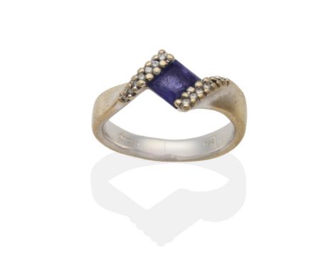 An 18 Carat White Gold Iolite and Diamond Twist Ring, a square cut iolite in a pavé set diamond tension setting, finger size 