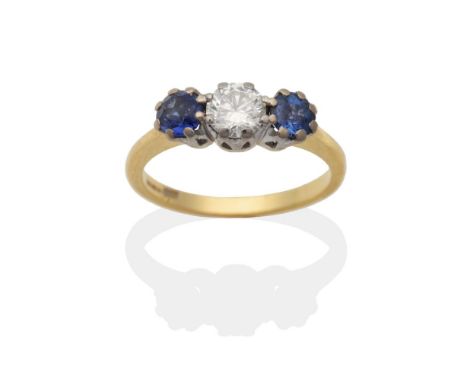 An 18 Carat Gold Diamond and Synthetic Sapphire Three Stone Ring, a round brilliant cut diamond between two round cut synthet