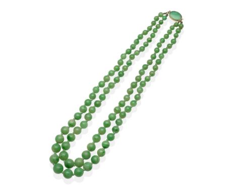 A Jade Necklace, a double strand of graduated jade beads knotted to a jade set oval clasp, shortest length 39.5cm see illustr