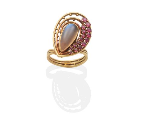 An 18 Carat Gold Moonstone and Ruby Cluster Ring, by Clare Street, a pear cut moonstone in a rubbed over setting within a pie