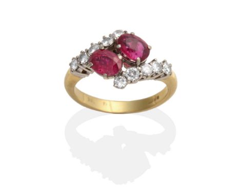 An 18 Carat Gold Ruby and Diamond Crossover Ring, two oval cut rubies in claw settings to shoulders set with round brilliant 