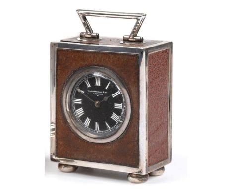 A Victorian Silver-Mounted and Leather Covered Desk Timepiece, Thornhill & Co., London 1884, with angular handle and raised o