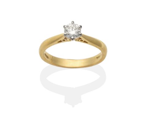 An 18 Carat Gold Diamond Solitaire Ring, a round brilliant cut diamond in a claw setting, to knife edge shoulders, estimated 