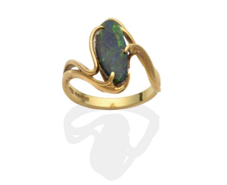 An 18 Carat Gold Black Opal Ring, an abstract oval black opal to scroll twist shoulders, finger size L1/2 see illustration Th