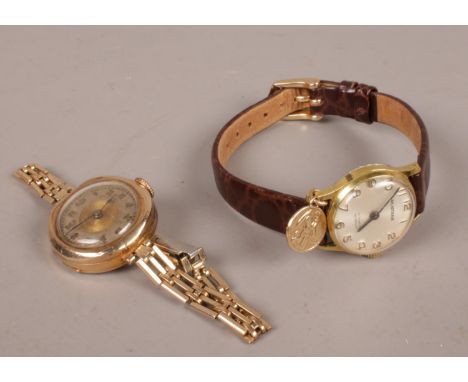 A ladies 9ct gold manual wristwatch along with a Huntana manual gold plated wristwatch with 9ct St Christopher fob.  