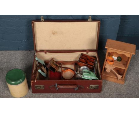 A leather case containing mostly kitchenaila. Including vintage fruit press, flour bin, etc.  