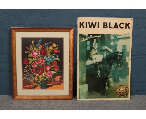 A framed picture of a floral needlepoint tapestry together with a metal advertising sign for Kiwi shoe polish. Kiwi sign - H-