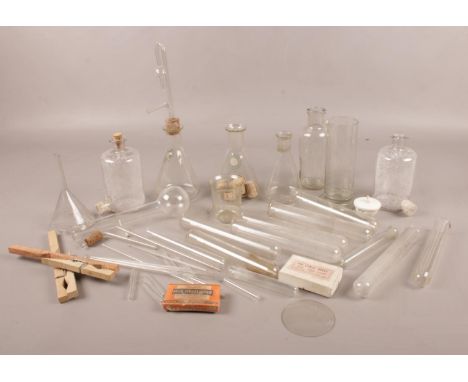 A collection of vintage chemistry equipment. Includes conical flasks, funnel, test tubes etc.  