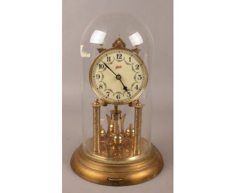 A Schatz brass torsion clock under glass dome. (30cm).  