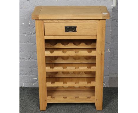 A light oak wine rack with drawer.  