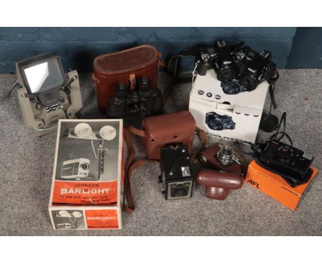 A box of camera and projector equipment. Including Kodak brownie box camera, two Nikon coolpix, Olympus AFL, etc.  