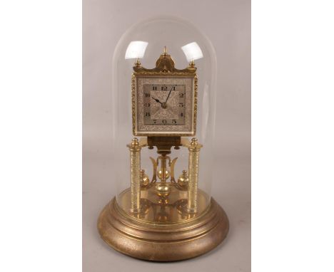 A German brass torsion clock under glass dome. (31cm).  