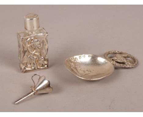 A silver caddy spoon with import marks along with a silver cased scent bottle and small silver funnel. 46g gross.  