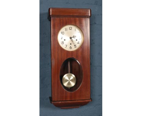A mahogany cased Enfield wall clock. Pendulum and key.  