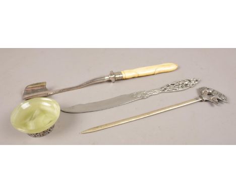 A collection of white metal items. Includes novelty WMF meat skewer, ivory handled stilton scoop, onyx dish with white metal 