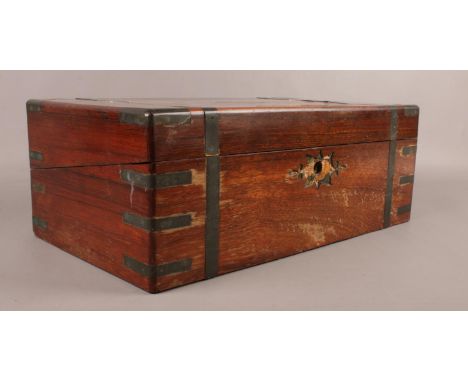 A Victorian Mahogany writing slope,  with brass mounts to the corners, straps and decoration to the top. H: 16cm, W:45cm, D: 