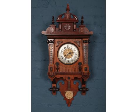 An early 20th Century carved Mahogany wall clock, with pendulum and twin train. H: 96cm, W:44.5cm, D: 17cm.  Clock looks like