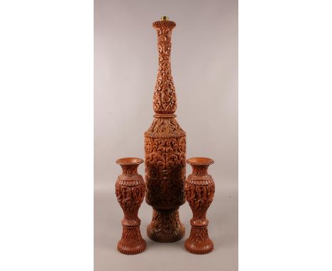 A large decorative wooden table lamp base, along with two similar vases. (Height of table lamp approximately 80cm).  