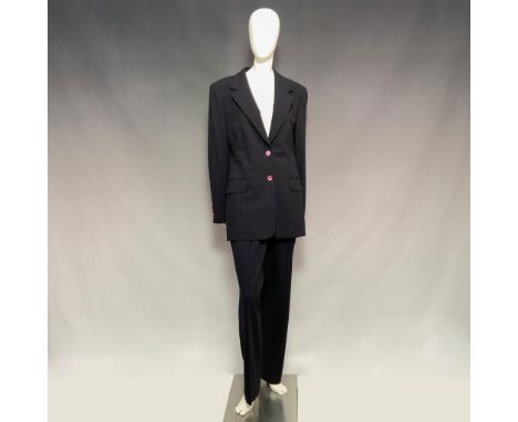 Crafted in black fabric with delicate pink stripes. Includes a tailored blazer with shoulder pads, two faux front pockets, fu