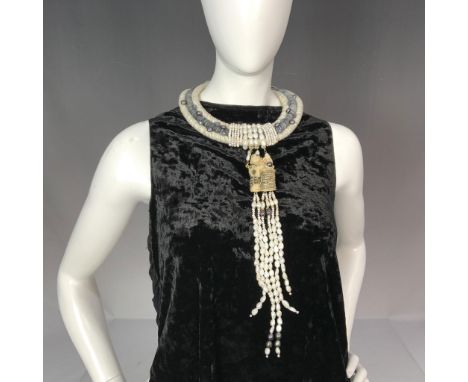 An extraordinary handmade conversation piece necklace featuring three distinct rows of pearls, each crafted with meticulous a