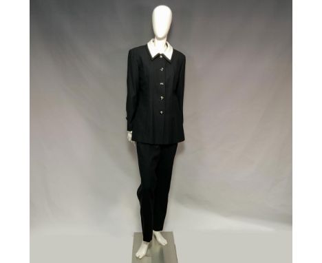 Black wool with delicate gray stripes featuring a blazer with structured shoulder pads, a crisp white collar and sleeve accen