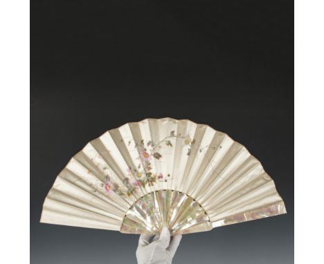 Magnificent hand fan featuring a mother of pearl handle that beautifully shines alongside a silk screen that is intricately d