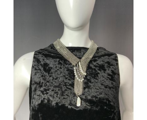 This handcrafted designer necklace features a double-sided stainless steel chain mail design, elegantly adorned with three ro